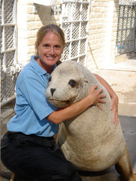 trainer with animal looking at the camera